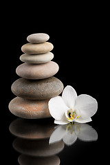 Image showing balancing zen stones on black with white flower