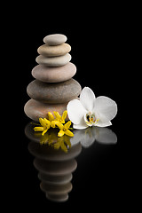 Image showing balancing zen stones on black with white flower