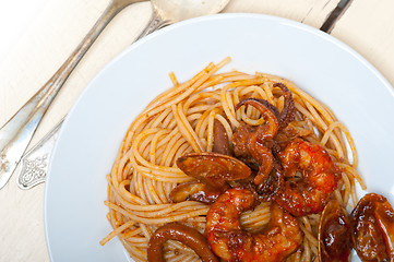 Image showing Italian seafood spaghetti pasta on red tomato sauce 