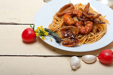 Image showing Italian seafood spaghetti pasta on red tomato sauce 