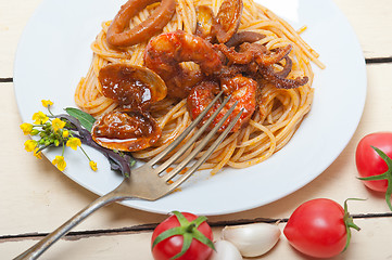 Image showing Italian seafood spaghetti pasta on red tomato sauce 