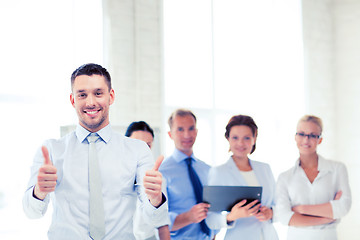 Image showing businessman in office showign thumbs up