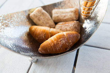 Image showing close up of buns in bowl at cafe or bakery