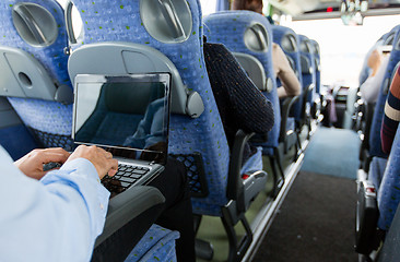 Image showing man with smartphone and laptop in travel bus