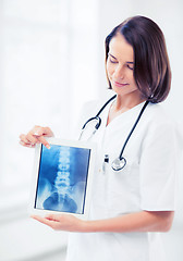 Image showing female doctor with x-ray on tablet pc