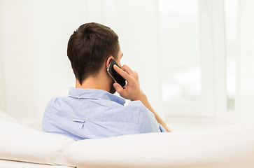 Image showing close up of man calling on smartphone at home