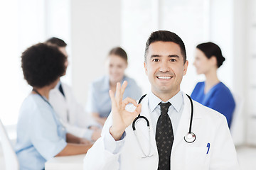 Image showing happy doctor over group of medics at hospital