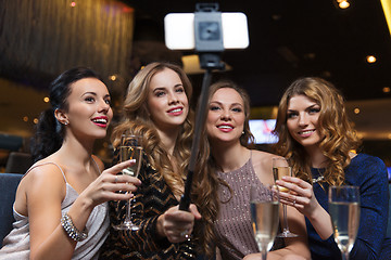 Image showing women with smartphone taking selfie at night club