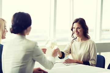 Image showing happy women drinking champagne at restaurant
