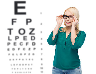 Image showing smiling young woman with eyeglasses