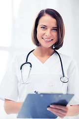 Image showing doctor with stethoscope writing prescription