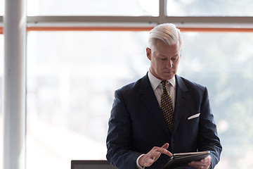 Image showing senior business man working on tablet computer