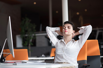 Image showing happy young business woman relaxing and geting insiration