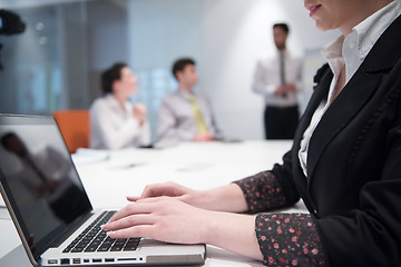 Image showing young business woman on meeting  using laptop computer