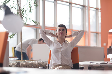 Image showing happy young business woman relaxing and geting insiration