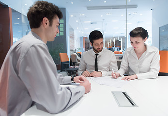 Image showing young couple signing contract documents on partners back