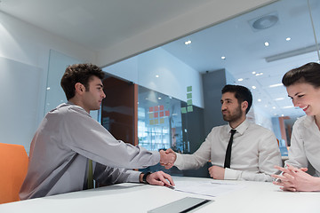 Image showing young couple signing contract documents on partners back