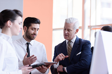 Image showing young startup businessman making presentation to senior investio