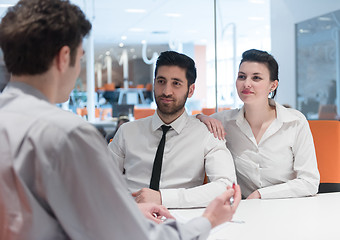 Image showing young couple signing contract documents on partners back