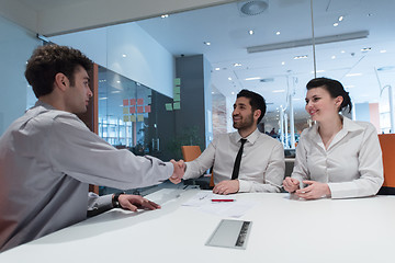 Image showing young couple signing contract documents on partners back