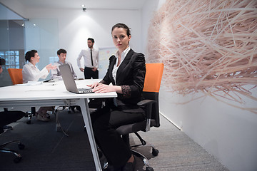 Image showing young business woman on meeting  using laptop computer