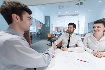 Image showing young couple signing contract documents on partners back