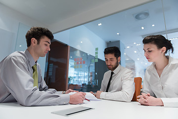 Image showing young couple signing contract documents on partners back