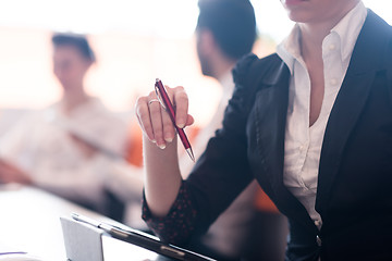 Image showing woman hands holding pen on business meeting