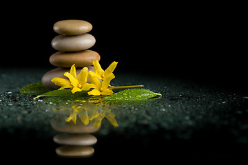 Image showing balancing zen stones on black with yellow flower