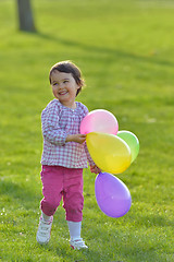 Image showing Girl with colorful balloons