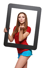 Image showing Female looking through the frame blowing a kiss