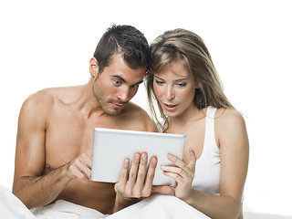 Image showing attractive couple watching things in a tablet