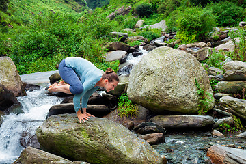 Image showing Woman doing Kakasana asana arm balance outdoors