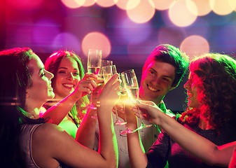 Image showing smiling friends with glasses of champagne in club