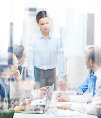 Image showing strict female boss talking to business team