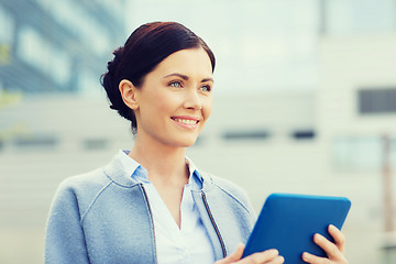 Image showing smiling business woman with tablet pc in city