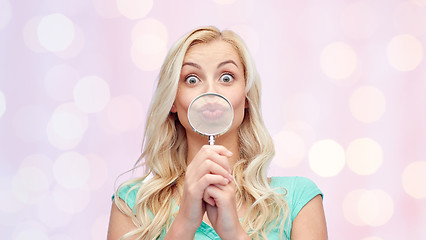 Image showing happy young woman with magnifying glass