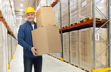 Image showing happy man or loader with box at warehouse