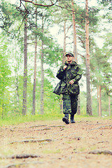 Image showing young soldier or hunter with gun in forest