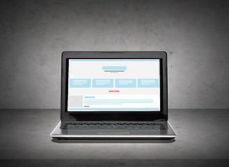 Image showing laptop computer with web design template on screen