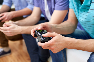 Image showing close up of friends playing video games at home