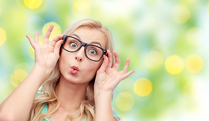 Image showing happy young woman in glasses making fish face