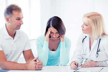 Image showing doctor with patients in cabinet