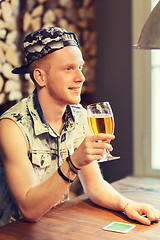 Image showing happy man drinking beer at bar or pub