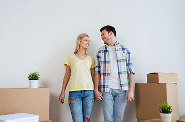 Image showing smiling couple with big boxes moving to new home