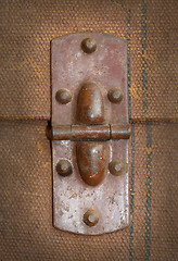 Image showing Old canvas trunk hinge close up