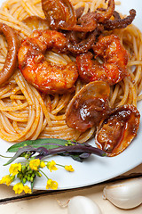 Image showing Italian seafood spaghetti pasta on red tomato sauce 