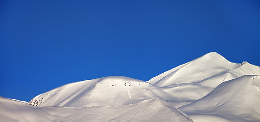 Image showing Panoramic view on off-piste slope and blue clear sky in morning