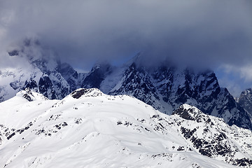 Image showing Snowy rocks in haze and storm clouds before blizzard