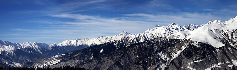 Image showing Panoramic view on snowy mountains in sun windy day